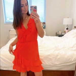 Cute red dress with small white polka dots and ruffle detailing.